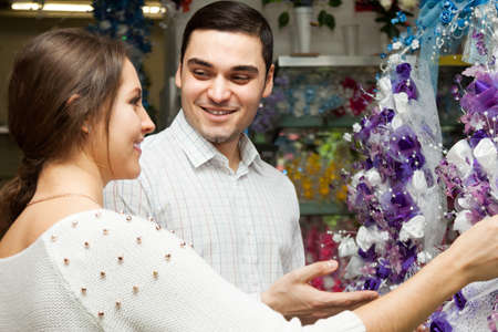 man and woman choosing  bouquet at  flower  section  in shopの写真素材