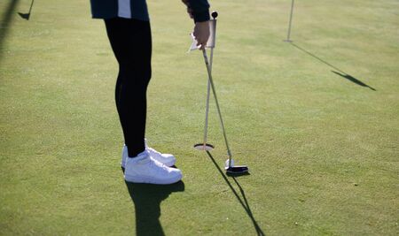 Putter to ball and takes aim at the golf courseの写真素材