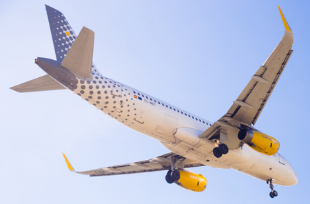 BARCELONA, SPAIN - MARCH 09, 2017:  Vueling Airlines plane landing in El Prat Airport on time. Barcelona, Spainのeditorial素材