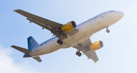 BARCELONA, SPAIN - MARCH 09, 2017:  Vueling Airlines plane landing in El Prat Airport on time. Barcelona, Spainのeditorial素材