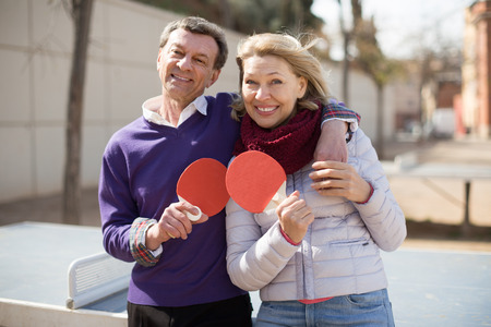 portrait of elderly couple with rackets for table tennisの写真素材