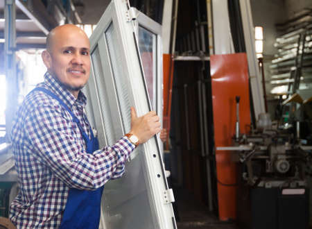 Portrait of smiling worker at PVC windows factory