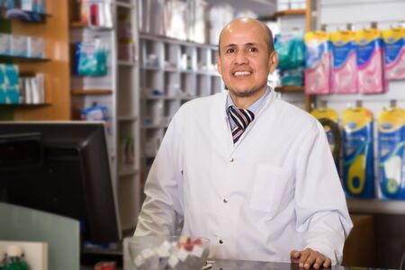 Portrait of smiling a pharmacist who wait clients in a pharmacyの写真素材