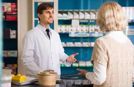 Mature female client buys drugs at the pharmacyの写真素材