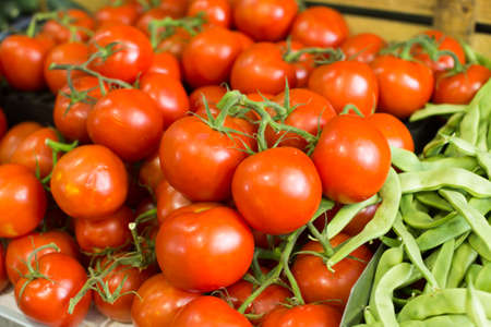 Fresh tomatoes on a branch on the counterの写真素材