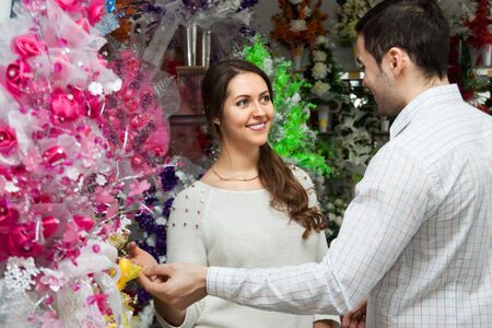 happy young  couple buying a bouquet at a flower shopの写真素材