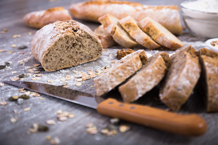 Fresh grain bread in a cut on a wooden tableの写真素材