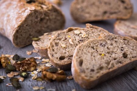 Fresh fragrant crispy loaf of bread on a wooden boardの写真素材