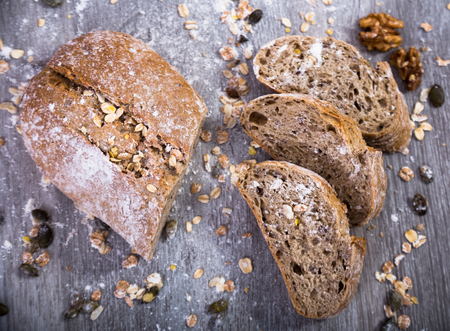 Fresh grain bread in a cut on a wooden tableの写真素材