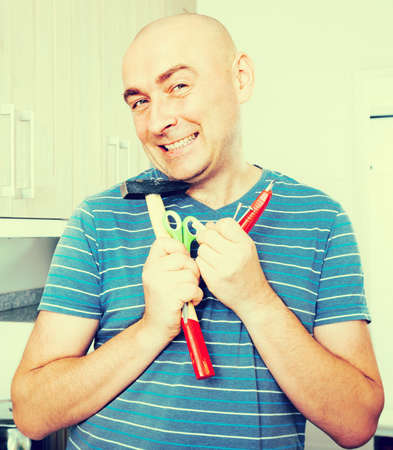 kind man posing with hammer in his handsの写真素材
