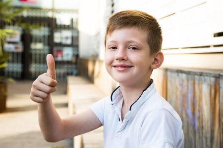 Portrait of boy showing thumbs upの写真素材