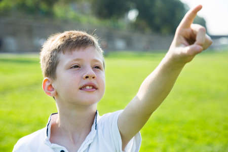 Portrait of english boy showing the distanceの写真素材