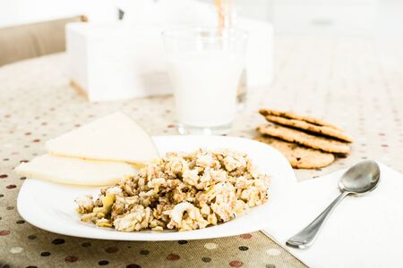 plate with cereal porridge and sheep cheese for wholesome breakfastの写真素材