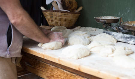 process of making bread in a traditional bakery. Focus on doughの写真素材
