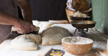 process of making bread in a traditional bakery. Focus on doughの写真素材
