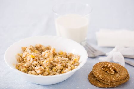 plate with cereal porridge for breakfast and cookiesの写真素材