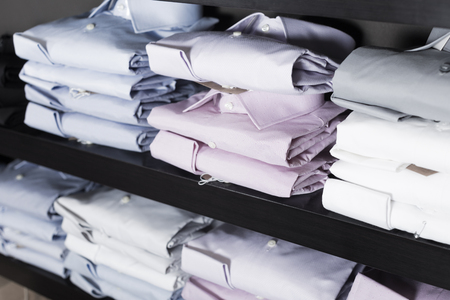 collection of shirts on shelfs in men clothing storeの写真素材