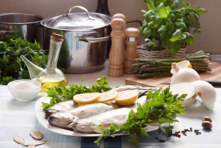 trout with Lemon, parsleyand onion lying on the plate indoorsの写真素材