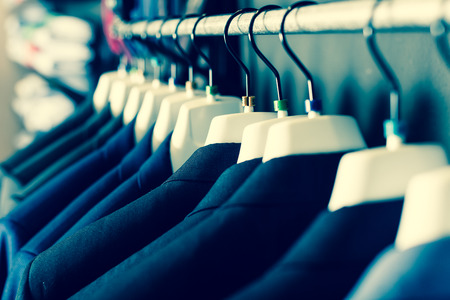 collection of jackets on hangers in men clothing storeの写真素材