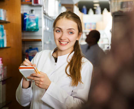 Smiling pharmacist posing in drugstoreの写真素材