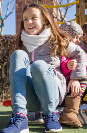 Happy two little girls spend time at playground in sunny fall dayの写真素材
