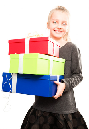 portrait of blonde girl holding in hands lots of boxes with gifts on isolated backgroundの写真素材