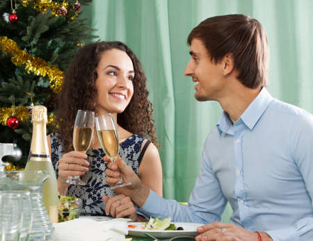 Young romantic couple celebrating the New Year together at homeの写真素材