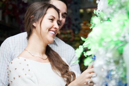 happy couple buying a bouquet at a flower shopの写真素材