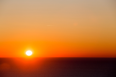 fiery sunrise over morning seaの写真素材