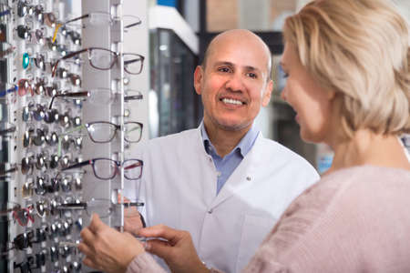 friendly  doctor consulting near eye chartの写真素材