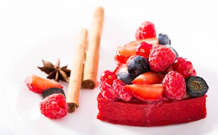 Delicious cake with fresh forest berries with cinnamon and aniseの写真素材