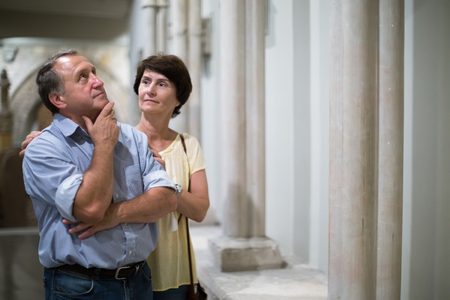 mature couple turists examines the exhibit in historical museumの写真素材