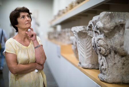 female collector evaluates the exhibition in historical museumの写真素材