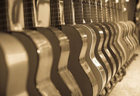 long row of new acoustic guitars in music chopの写真素材
