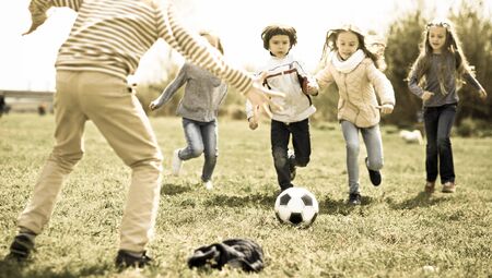 funny Children play with ball outdoors in springの写真素材