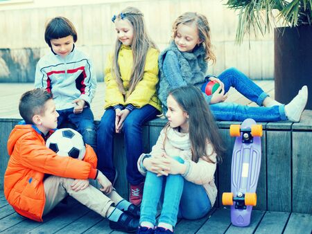 children communicate on wooden scaffolding schoolyardの写真素材