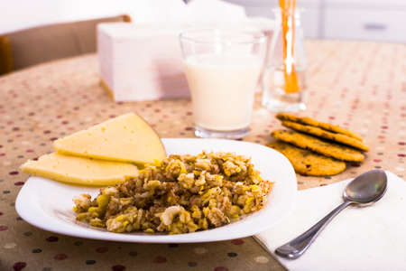 plate with cereal porridge and sheep cheese for breakfastの写真素材