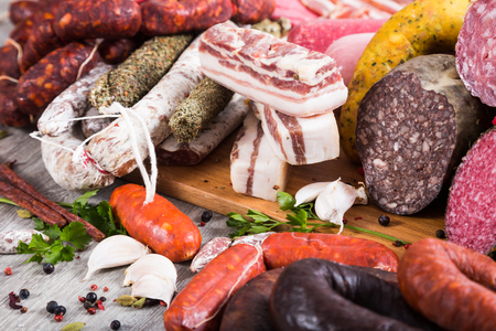 a bunch of meat and sausages of various kindsの写真素材