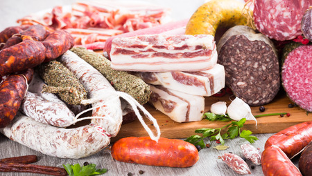 a bunch of meat and sausages of various kindsの写真素材