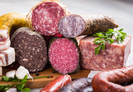 a bunch of meat and sausages of various kindsの写真素材