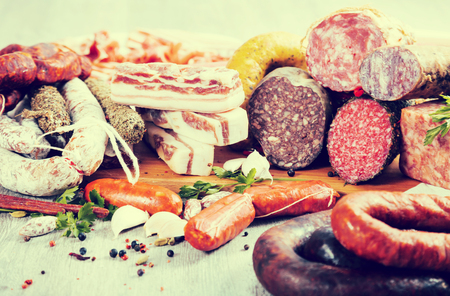 a bunch of meat and sausages of various kindsの写真素材
