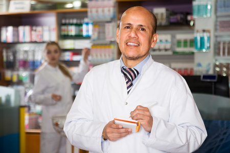 Portrait of male pharmacists working in modern drugshopの写真素材