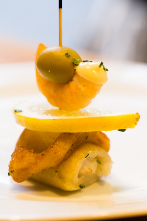 Sophistication pintxos with shrimps lemon and oliveの写真素材