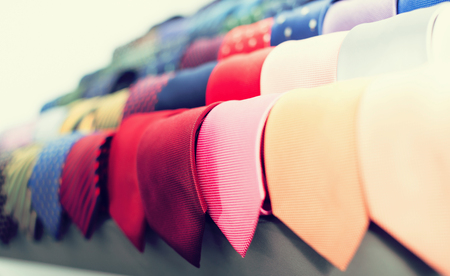 row of Neckties on hangers in men clothing storeの写真素材
