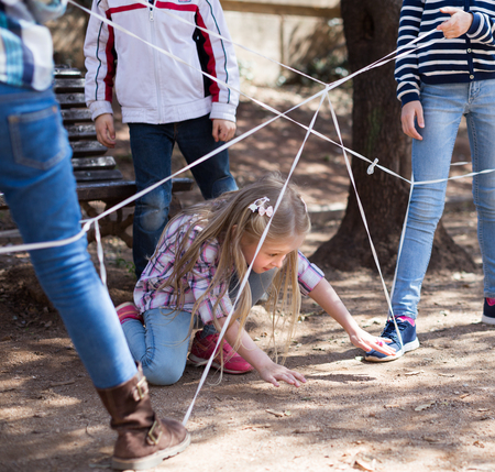 children games. active Girl goes through the tangled ropeの写真素材