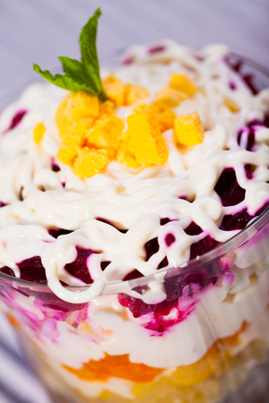 verrin with appetizing salad herring under fur coat from vegetables on striped tableclothの写真素材