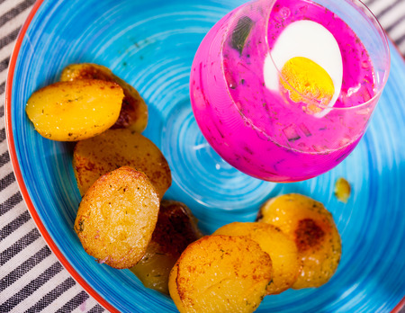 Belarusian cold beet soup in verrin glass serving on plate with fried potatoesの写真素材