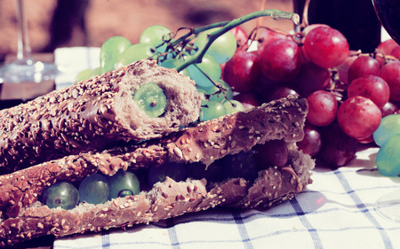 fresh sandwich with green grapes on table in vineyardの写真素材