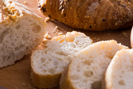 fresh slices of wheaten bread on wooden surfaceの写真素材