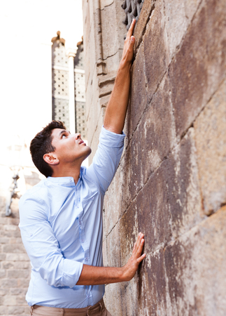 ordinary young European guy in blue shirt walking around cityの写真素材